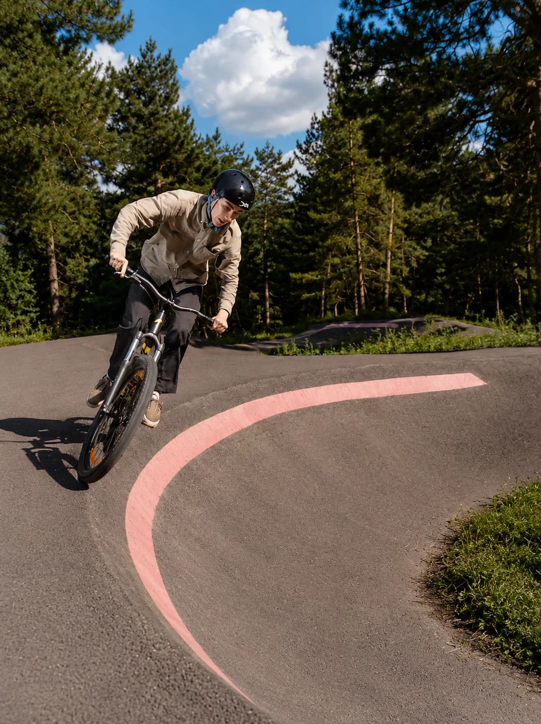 Rider carving a Boo Park pump-track berm